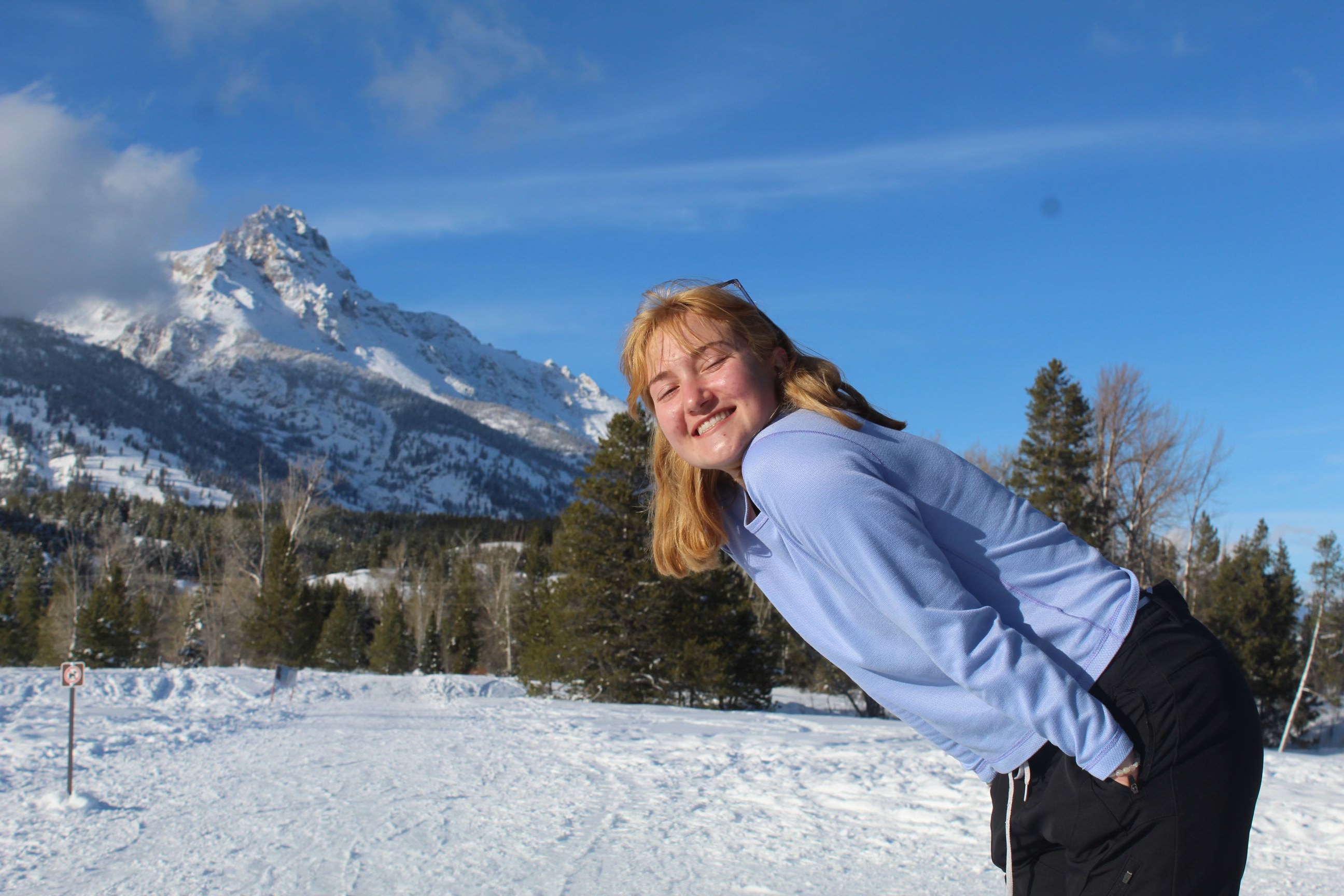 Leila pses with Tetons