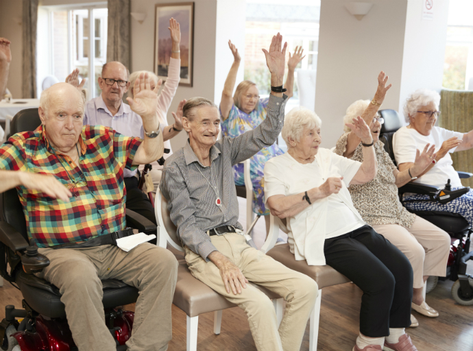 Older adults raising hands