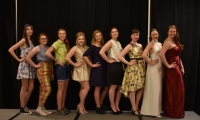 Nine women in various fashions stand together