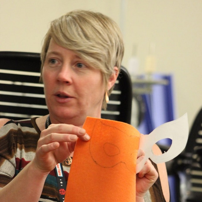 Jane Crayton holding an orange piece of paper