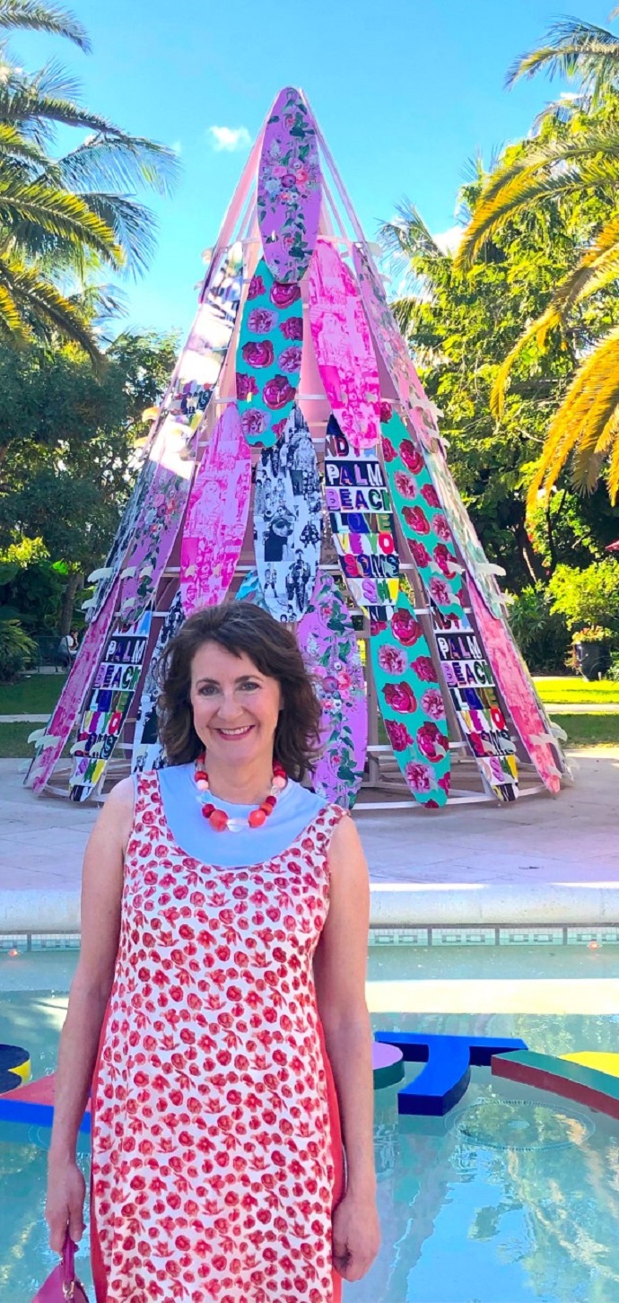 Martha McCaughey in front of a colorful art installation