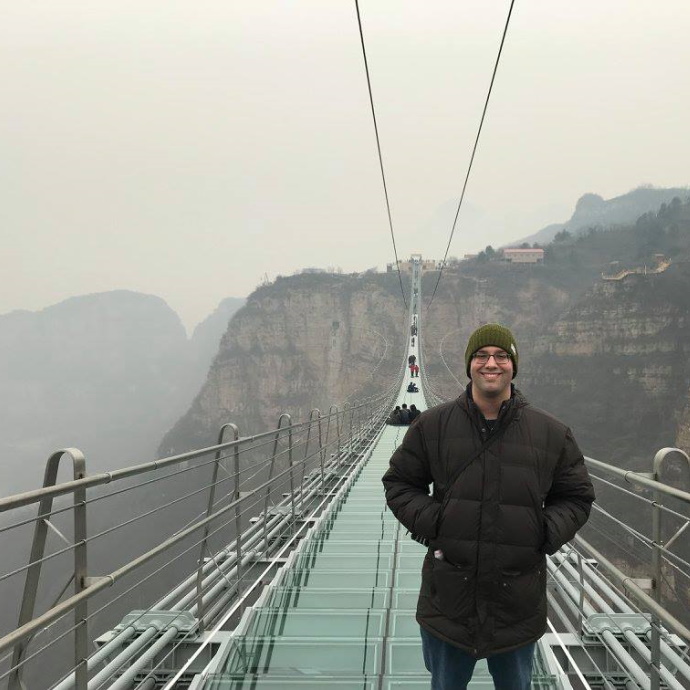 Matt Liu standing on a suspension bridge