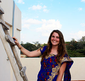 woman with hand on wooden ladder