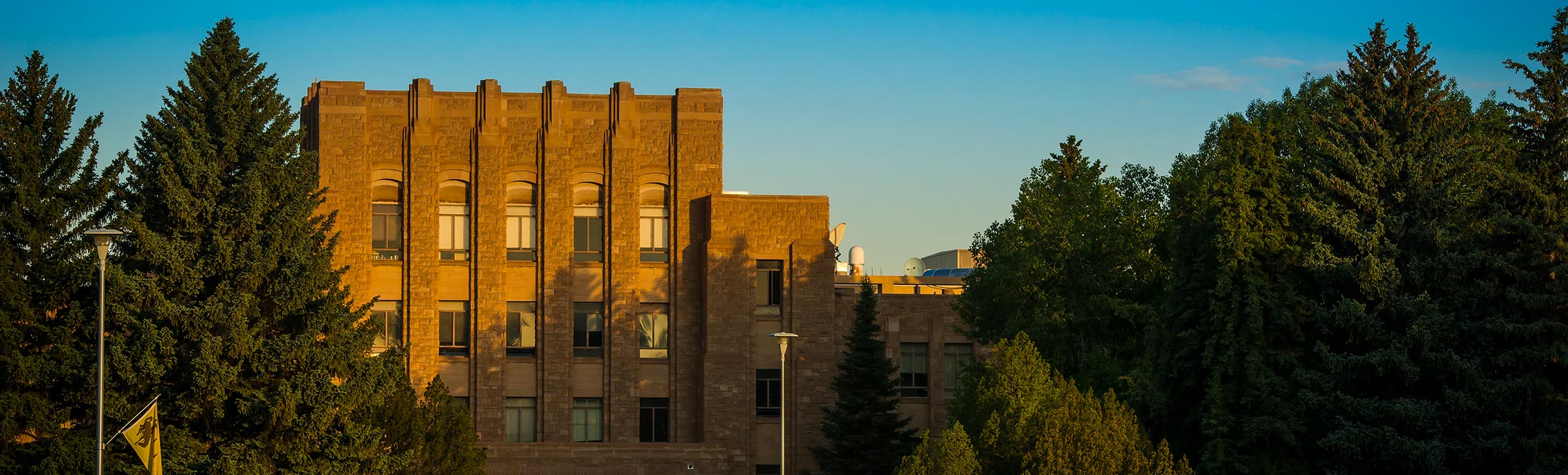the college of arts and science building at sunset
