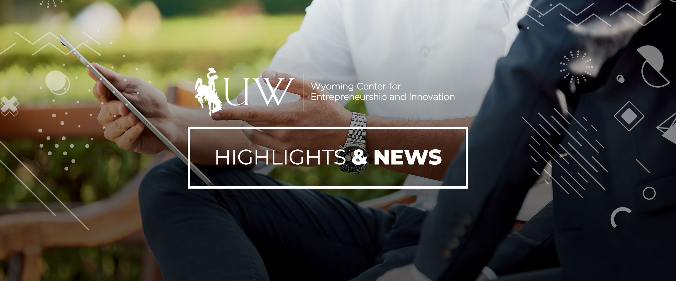 Two people talking with ipad with Highlights & News and University of Wyoming Center for Entrepreneurship & Innovation logo