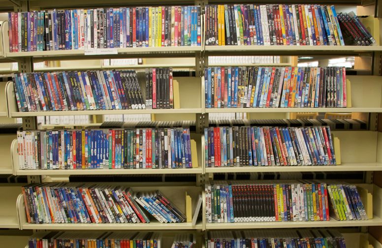 A shelf of movies in the media collection in Coe library.