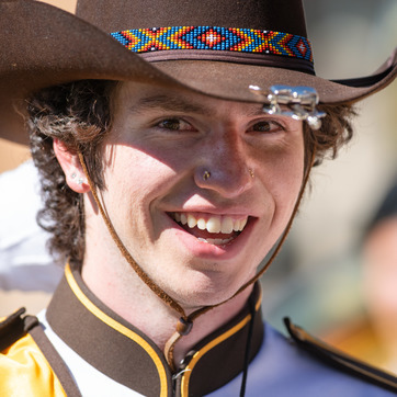 Picture of Western Thunder Marching Band Drum Major smiling at camera while in uniform with a cowboy hat.