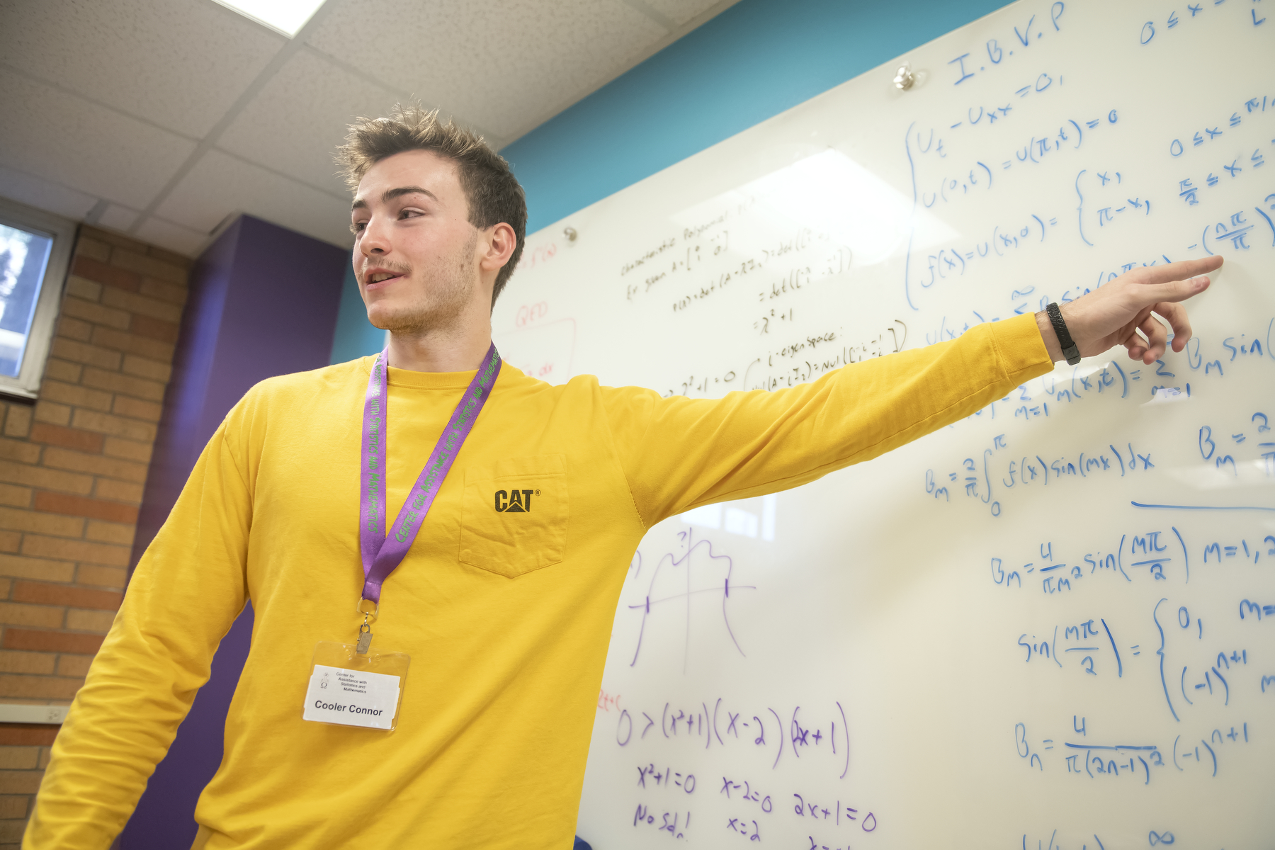 Tutor pointing to math on a board