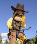 photo of mascot, pistol pete, riding a bicycle