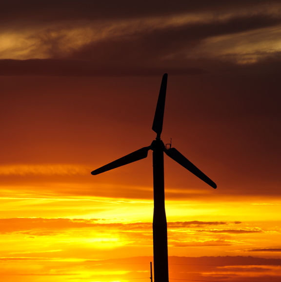 photo of wind turbine at sunset