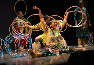 Students participate in a dance wearing traditional Native American clothing for their tribe as part of a performance put on by the Native center.