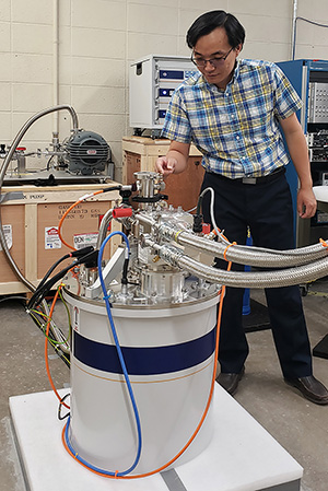 man working with large equipment in a lab