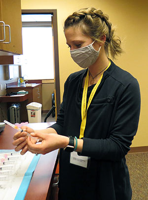 woman preparing syringe