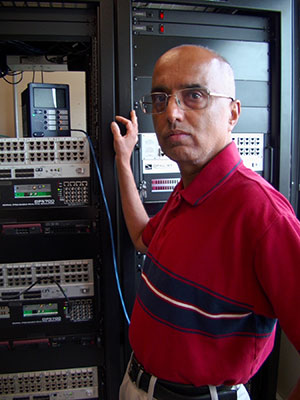 man standing beside electronic control boards