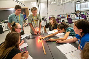 group of teens examining a radiometer