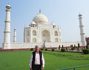 man standing in front of the Taj Majal