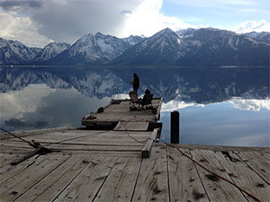 people fishing in a peaceful mountain lake
