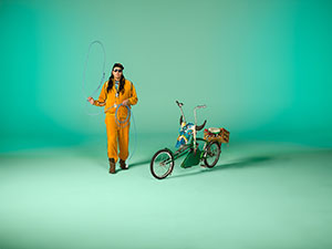 person and bicycle against green background