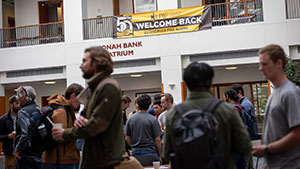 people in an atrium with a banner overhead
