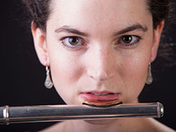 head photo of a woman playing a flute