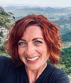 head photo of a woman with mountains in the background