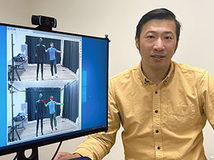 man with a screen displaying two images of people