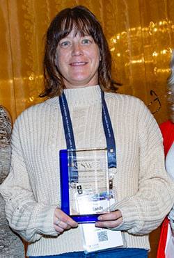 woman holding an award