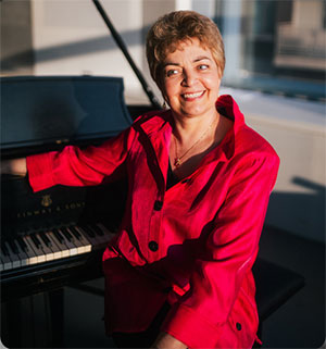 woman posing at a grand piano