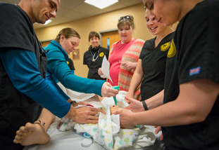 Students in the UW nursing program and local medical professionals participate in a lesson with simulator patients.
