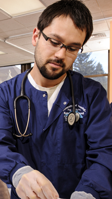 David Cortes practices nursing skills in the school's Clinical Simulation Center.