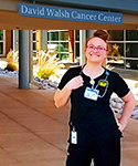 Katy Morrison standing in front of the David Walsh Cancer Center
