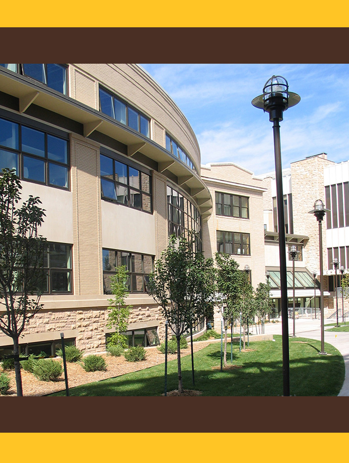east side of health sciences center with green grass and trees