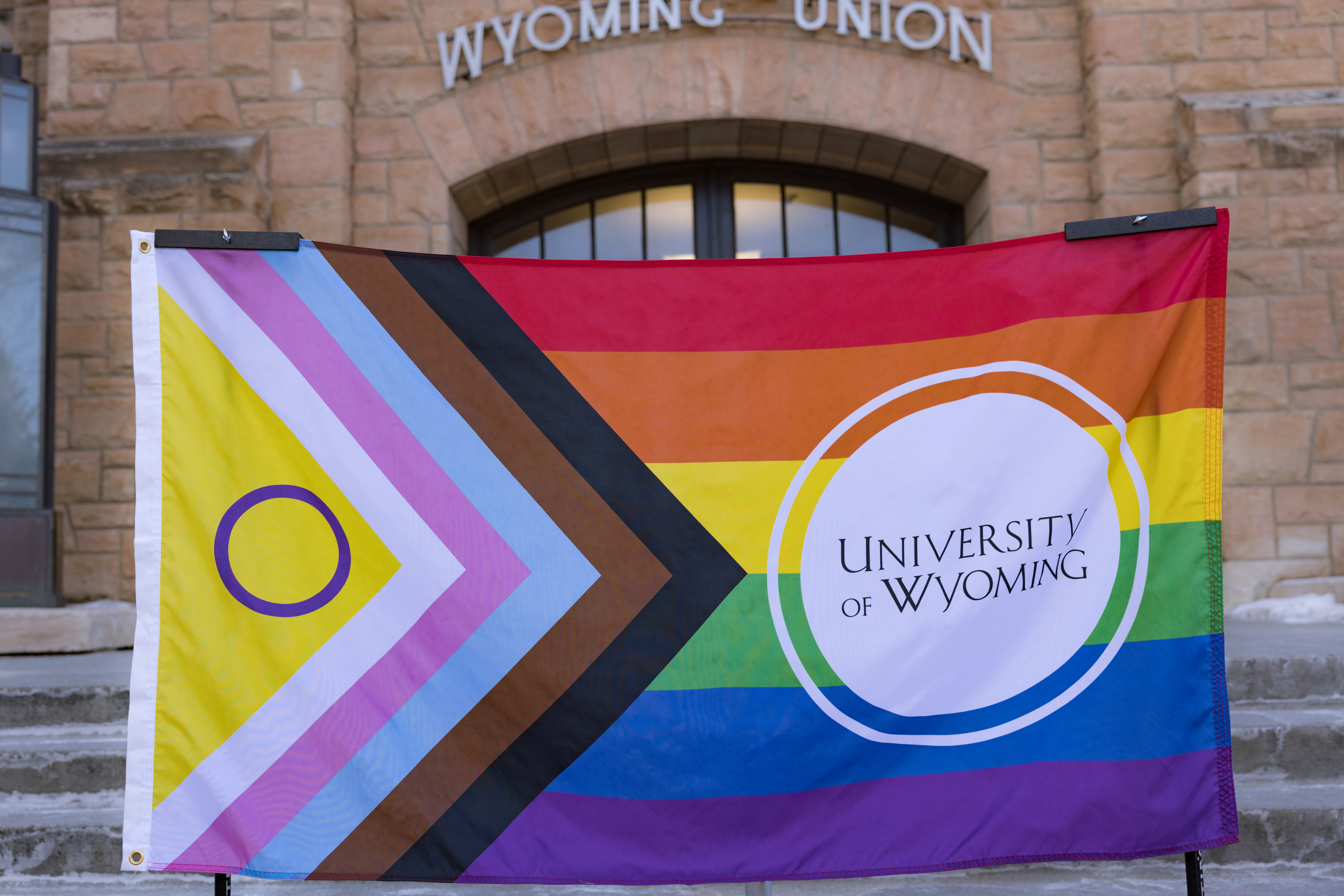 The Wyoming Union building outside with a pride flag in front.