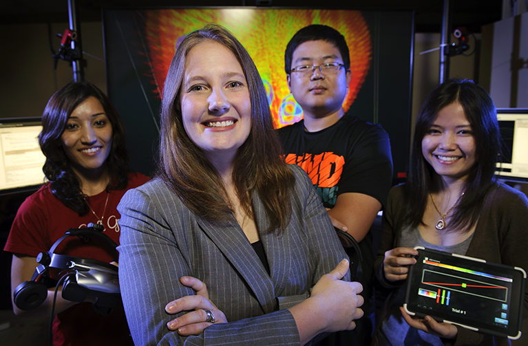 A group of UW students in the lab smile at camera.