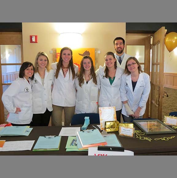 UW Pharmacy students staffing an information table. 