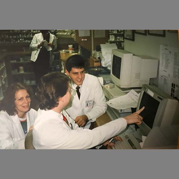 Pharmacy students using a computer. 
