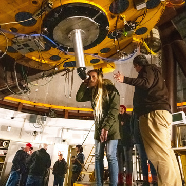 student using telescope