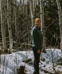 Emma H stands in a grove of Aspen trees