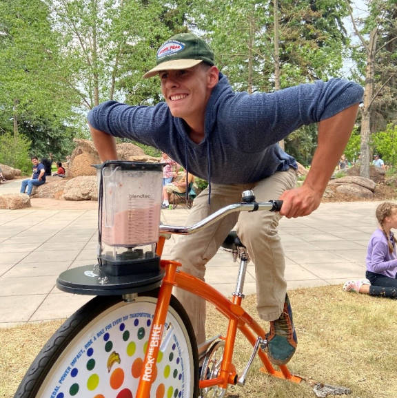 A Wellness Ambassador rides the Smoothie Bike