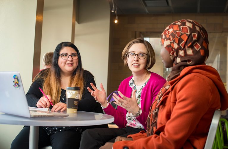 People chatting in coffee shop on campus