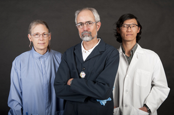 Three people wearing lab coats