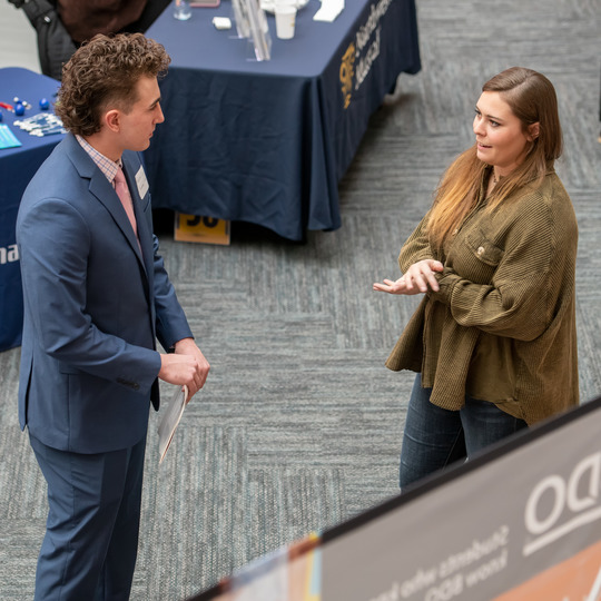 A student speaking with a recruiter at a recent career fair at UW.