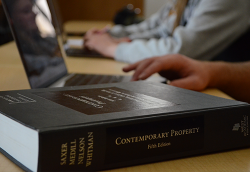 A close up of a property law book on a table in a classroom