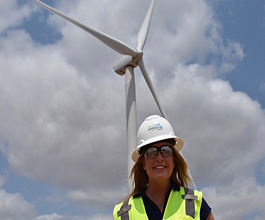 Desa Inskeep standing in front of a wind turbine