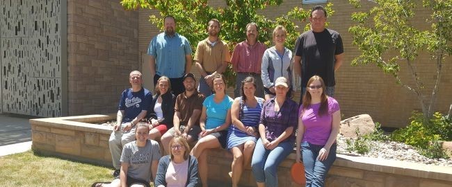 MMA group photo sitting in the sun outside on the University of Wyoming's Laramie campus