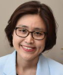 Lady with short dark hair wearing glasses. 