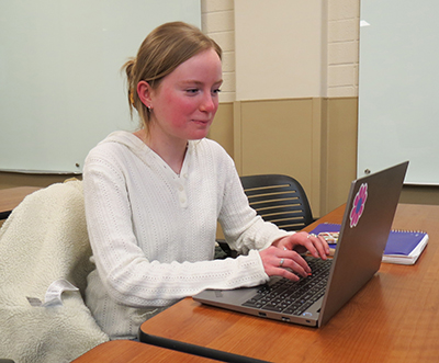 A female student using a laptop.