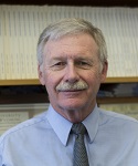 photograph of Dr. Jim King in front of a bookshelf