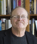 photograph of Dr. Thomas Seitz in front of a bookshelf