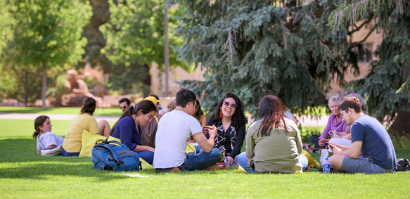 Students sitting on grass in Prexy's Pasture